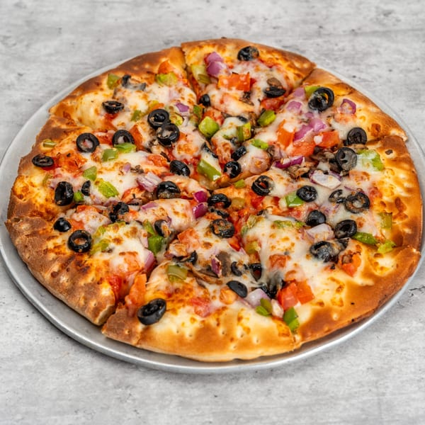 Waterfront Pizza's veggie pizza, topped with olives, green peppers, red onions, and tomatoes.